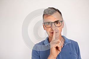 Attractive man in glasses calling be silent