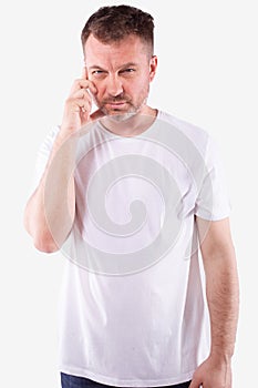 Attractive man with grey beard concentrating, hand on winkle. White background