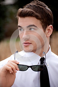 Attractive Man Holding Sunglasses