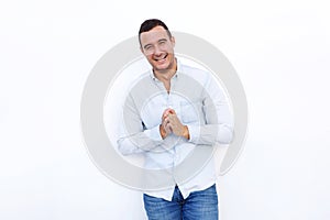 Attractive man laughing with hands clasp against  white background