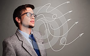 Attractive man looking at multiple curly arrows