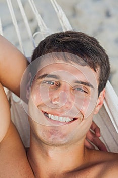 Attractive man lying in hammock