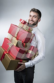Attractive man with many present boxes in his arms