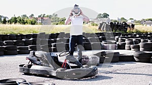 Attractive man putting on a helmet before getting into his gocart