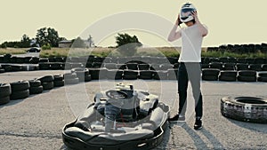 Attractive man putting on a helmet before getting into his gocart