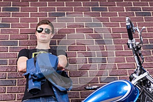 Attractive Man in Shades with Jacket and Motorbike