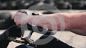 Attractive man sititng in a gocart on the track