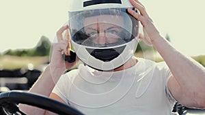 Attractive man sititng in a gocart on the track