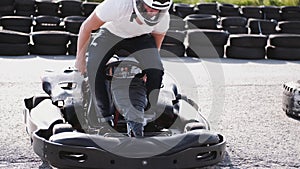 Attractive man sititng in a gocart on the track