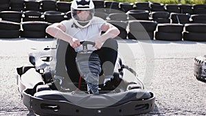 Attractive man sitting in a go cart on the track
