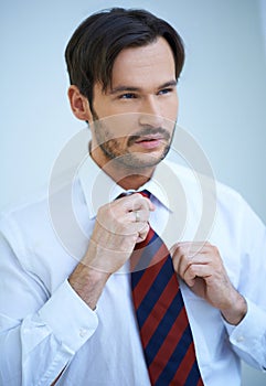 Attractive man straightening his tie