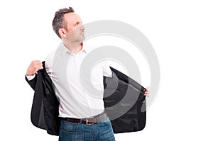 Attractive man taking off his suit jacket photo