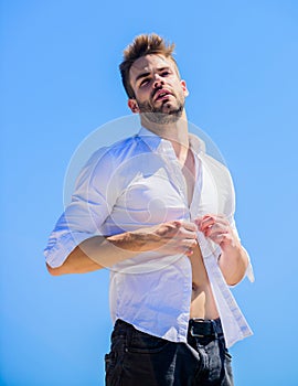 Attractive man taking off shirt. Confident in his appealing. Bearded guy business style. Handsome man fashion model