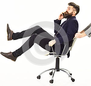 Attractive man talking on cell sitting on chair