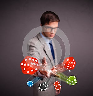 Attractive man throwing dices and chips