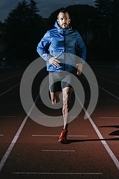 Attractive man Track Athlete Running On Track