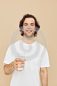 Attractive man transparent glass of water health beige background