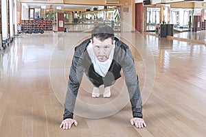 Attractive man warming up and doing some push-up