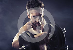 Attractive man weightlifting