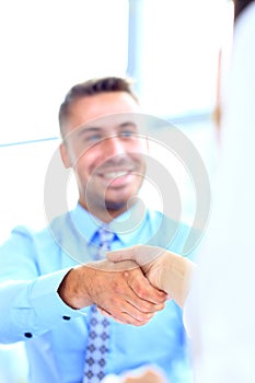 Attractive man and woman business team shaking hands