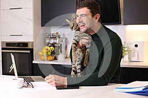 Attractive man working from home with his cat