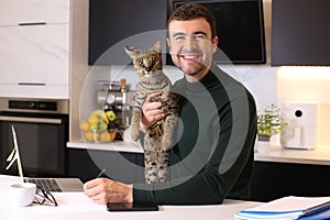 Attractive man working from home with his cat