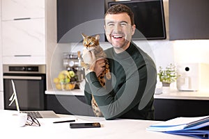 Attractive man working from home with his cat