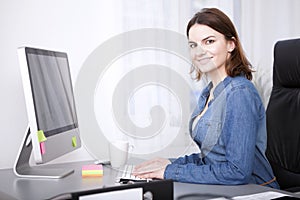 Attractive manageress working at her desktop