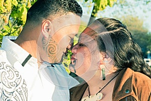 An attractive Maori couple connected in a traditional hongi photo