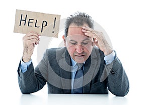 Attractive mature businessman overwhelmed and tired holding a help sign