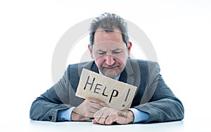 Attractive mature businessman overwhelmed and tired holding a help sign