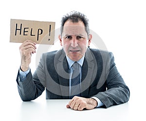 Attractive mature businessman overwhelmed and tired holding a help sign