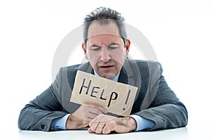 Attractive mature businessman overwhelmed and tired holding a help sign