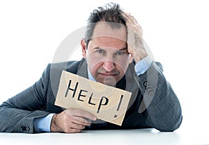 Attractive mature businessman overwhelmed and tired holding a help sign