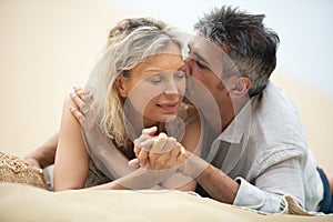 attractive mature couple relaxing on beach