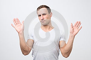 Attractive mature man shows refusal gesture, does not want to participate in meeting