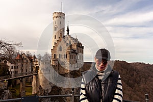 Attractive mature traveler in front of the famous Liechtenstein Castle near Honau