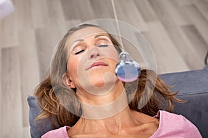 Woman Being Hypnotized While Lying On Sofa photo