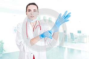 Attractive medic putting gloves on