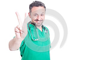 Attractive medic showing peace sign or number two