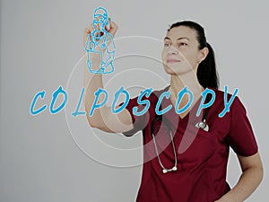 Attractive medico with marker writing COLPOSCOPY Cervical Biopsy photo