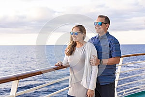 Attractive middle-aged couple enjoying the balcony view from the deck of a cruise ship