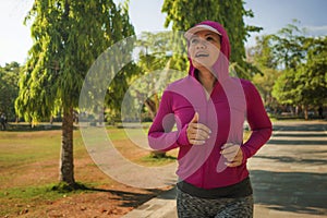 Attractive middle aged lady running happy at city park . beautiful and sporty woman on her 40s exercising doing jogging workout on