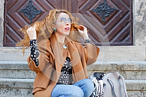 Attractive middle aged white caucasian woman with waved curly red hair and sun glassess