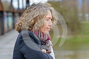 Attractive middle-aged woman deep in thought