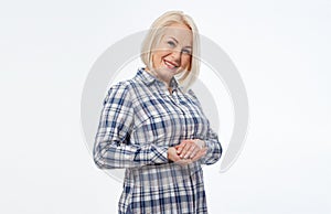 Attractive middle aged woman with folded arms on white background