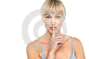 Attractive middle aged woman gesturing silence