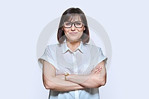 Attractive middle aged woman looking at camera on white background