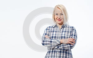 Attractive middle aged woman in a plaid shirt with folded arms isolated on white background