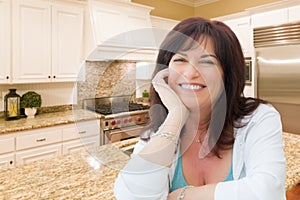 Attractive Middle Aged Woman Portrait Inside Kitchen At Home